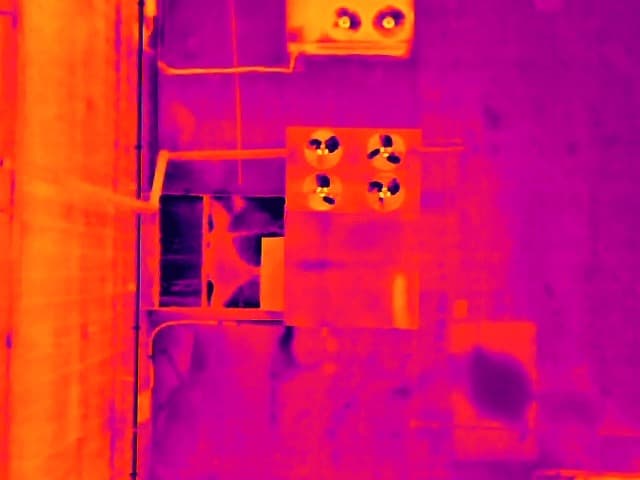 Thermal aerial image of the same anonymized commercial roof area