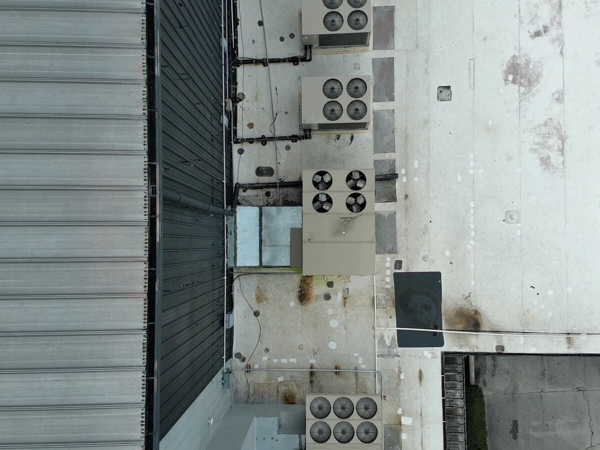 Visible-light aerial image of an anonymized commercial roof and rooftop equipment